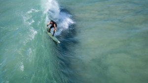 a man surfing in a wave